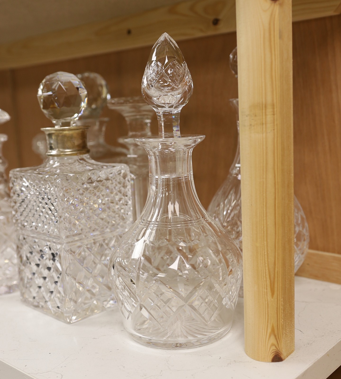 A silver mounted decanter, four others and a smaller pair of decanters, tallest 27.5cm